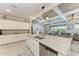 Open-concept kitchen with a large island, stainless steel appliances, and a view into the living room at 15169 Spanish Point Dr, Port Charlotte, FL 33981