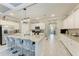 Bright kitchen featuring a large island with seating, granite countertops, and modern appliances at 15169 Spanish Point Dr, Port Charlotte, FL 33981