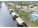 Aerial view of waterfront homes featuring pools, boat docks, and lush tropical landscaping at 18305 Wolbrette Cir, Port Charlotte, FL 33948