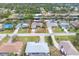 Overhead view of a residential area featuring homes, canals, and lush green foliage at 18305 Wolbrette Cir, Port Charlotte, FL 33948