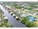 An aerial view of waterfront homes with private docks and beautiful landscaping along a serene canal at 18305 Wolbrette Cir, Port Charlotte, FL 33948