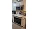 The kitchen showcases stainless steel appliances with white cabinetry and granite countertops at 21354 Austin Ave, Port Charlotte, FL 33952