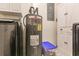 Close up of Rheem hot water heater and Samsung front load washer and dryer in laundry room at 21354 Austin Ave, Port Charlotte, FL 33952
