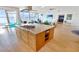 Gourmet kitchen featuring a large center island with stone countertops and breakfast bar with stunning water views at 311 Bayridge Pl, Punta Gorda, FL 33950