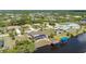 Aerial view of waterfront home with screened in lanai, boat dock, and lift at 4122 Library St, Port Charlotte, FL 33948
