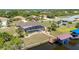 Wide aerial perspective of the canal-front property with pool, dock, and surrounding neighborhood at 4122 Library St, Port Charlotte, FL 33948