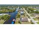 Beautiful aerial view of canal homes with docks and some pools, surrounded by lush greenery at 4122 Library St, Port Charlotte, FL 33948