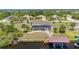 Aerial view of a canal-front home with screened pool, boat dock, and well-maintained landscaping at 4122 Library St, Port Charlotte, FL 33948