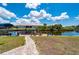 A brick paver walkway leads from the green yard to the waterfront dock with seating area at 4122 Library St, Port Charlotte, FL 33948