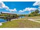 Spacious backyard leads to a waterfront dock with covered boat lift and canal views at 4122 Library St, Port Charlotte, FL 33948
