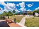 Lovely backyard with green grass, tropical landscaping, a paved walkway, and enclosed pool at 4122 Library St, Port Charlotte, FL 33948