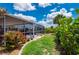 Enclosed pool area featuring a lush green yard and well-maintained landscaping at 4122 Library St, Port Charlotte, FL 33948