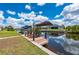 Waterfront dock with boat lift, canopy, and chairs overlooking the calm canal at 4122 Library St, Port Charlotte, FL 33948