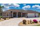 Attractive home boasts a three-car garage, well-manicured lawn, and lovely landscaping at 4122 Library St, Port Charlotte, FL 33948