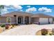 Elegant home with a three-car garage, circular driveway, and meticulously maintained landscaping at 4122 Library St, Port Charlotte, FL 33948