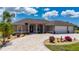 Inviting home featuring a three-car garage, a circular driveway, and meticulously designed landscaping at 4122 Library St, Port Charlotte, FL 33948
