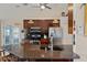 Kitchen with dark wood cabinets, stainless steel appliances, granite countertops, and breakfast bar seating at 4122 Library St, Port Charlotte, FL 33948
