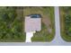 Overhead angle shows a well-maintained home with pool and generous driveway, surrounded by lush greenery at 5435 Montego Ln, Port Charlotte, FL 33981