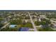 Expansive aerial view of a neighborhood with a variety of single-Gathering homes surrounded by lush greenery at 5435 Montego Ln, Port Charlotte, FL 33981