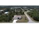 Aerial shot of home with three-car garage, driveway and lush greenery at 5435 Montego Ln, Port Charlotte, FL 33981