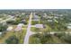 Bird's eye view captures a well-maintained home with pool, surrounded by serene neighborhood, near wooded landscape at 5435 Montego Ln, Port Charlotte, FL 33981