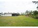 Expansive backyard features a covered, screened-in pool area, perfect for private outdoor entertainment and relaxation at 5435 Montego Ln, Port Charlotte, FL 33981