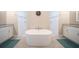 Bright bathroom with a standalone tub between dual sink vanities and tiled shower at 5435 Montego Ln, Port Charlotte, FL 33981