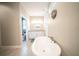 Spa-like bathroom featuring a large soaking tub, vanity, and a view of the commode at 5435 Montego Ln, Port Charlotte, FL 33981