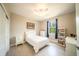 Cozy bedroom with a ceiling fan, light-colored walls and wood-look flooring, and a bright window at 5435 Montego Ln, Port Charlotte, FL 33981