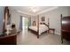 Main bedroom featuring wood-look flooring, crown molding, and sliding doors leading to an outdoor area at 5435 Montego Ln, Port Charlotte, FL 33981