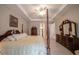 Spacious bedroom with tray ceiling, four-poster bed, and wood flooring at 5435 Montego Ln, Port Charlotte, FL 33981