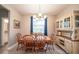 Cozy dining room with classic furniture, a stylish light fixture, and view to the backyard at 5435 Montego Ln, Port Charlotte, FL 33981