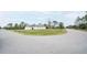 A charming home situated on a corner lot features a well-maintained lawn and a spacious three-car garage at 5435 Montego Ln, Port Charlotte, FL 33981