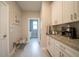 Hallway featuring white cabinets with granite countertops and a beverage station at 5435 Montego Ln, Port Charlotte, FL 33981