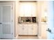 Hallway featuring white cabinets with granite countertops and a beverage station at 5435 Montego Ln, Port Charlotte, FL 33981
