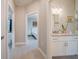 Bright hallway leading to the bathroom and bedroom with neutral paint, and gray wood-look tile flooring at 5435 Montego Ln, Port Charlotte, FL 33981