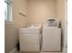 Laundry room featuring a modern washer and dryer with a small window above at 5435 Montego Ln, Port Charlotte, FL 33981