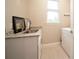 Functional laundry room with a sink, granite countertops, and built-in shelving at 5435 Montego Ln, Port Charlotte, FL 33981