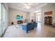 Spacious living room boasts wood floors, tray ceiling, and sliding glass doors for seamless indoor-outdoor living at 5435 Montego Ln, Port Charlotte, FL 33981