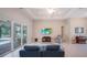Living room features tiled floors, a decorative rug, and seamless access to the screened patio and pool at 5435 Montego Ln, Port Charlotte, FL 33981