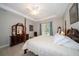 Spacious main bedroom with wood-look floors, tray ceiling, and access to the outdoors at 5435 Montego Ln, Port Charlotte, FL 33981