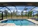 Inviting screened-in pool area with a sparkling pool and a view of the green backyard at 5435 Montego Ln, Port Charlotte, FL 33981