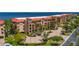 A luxury condo offers red roofs, elegant balconies, lush landscaping, and coastal living, creating an inviting retreat at 89 Vivante Blvd # 205, Punta Gorda, FL 33950