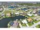 Breathtaking aerial shot of a residential neighborhood featuring canal-front properties, private docks, lush landscaping, and waterfront views at 3663 Whippoorwill Blvd, Punta Gorda, FL 33950