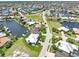 A picturesque aerial view of waterfront homes nestled along winding canals in a serene and established residential community at 3663 Whippoorwill Blvd, Punta Gorda, FL 33950