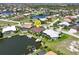 An overhead view of a waterfront home with private dock, screened lanai, and lush landscaping in a desirable neighborhood at 3663 Whippoorwill Blvd, Punta Gorda, FL 33950