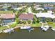 A high aerial view showcases waterfront living with private boat docks, screened lanais, and meticulously maintained landscaping at 3663 Whippoorwill Blvd, Punta Gorda, FL 33950