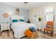 Bright bedroom features white furniture, wood-look flooring, and blue accent wall for a relaxing atmosphere at 3663 Whippoorwill Blvd, Punta Gorda, FL 33950