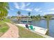 Waterfront dock with boat lift and seating, perfect for relaxing and enjoying the waterfront view at 3663 Whippoorwill Blvd, Punta Gorda, FL 33950