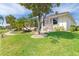 Well-maintained home exterior with lush landscaping, mature trees and brick pathway at 3663 Whippoorwill Blvd, Punta Gorda, FL 33950